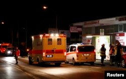 German emergency services workers work in the area where a man with an ax attacked passengers on a train near the city of Wuerzburg, July 19, 2016.