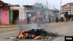 Tires burn on a road in Nairobi's Kibera slum August 10, 2017, during protests over preliminary presidential election results that pitted incumbent Uhuru Kenyatta against opposition leader Raila Odinga. (J. Craig/VOA)