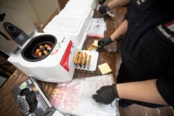 An EMT matches the number on a tube to the number of samples during a COVID-19 antibody test drive at the Abyssinian Baptist Church, May 14, 2020, in New York. (AP Photo/Mary Altaffer)