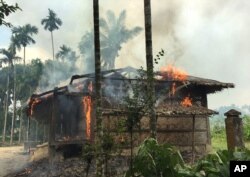 FILE - Houses are on fire in Gawdu Zara village, northern Rakhine state, Myanmar, Sept. 7, 2017.