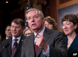 Sen. Lindsey Graham, R-S.C., flanked by Sen. Mike Rounds, R-S.D., left, and Sen. Susan Collins, R-Maine, discusses efforts to reach agreement on immigration reform, during a news conference at the Capitol in Washington, Feb. 15, 2018.
