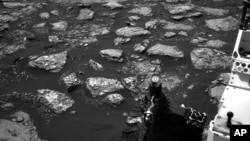 This Dec. 2, 2016 image taken by NASA's Curiosity rover shows rocky ground on the lower flank of Mount Sharp, a mountain on Mars. Curiosity landed on the red planet in 2012 and uncovered geologic evidence of an ancient environment.