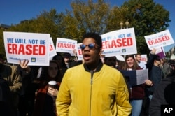 The National Center for Transgender Equality, NCTE, and the Human Rights Campaign gather on Pennsylvania Avenue in front of the White House in Washington, Oct. 22, 2018, for a #WontBeErased rally.