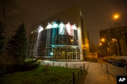A man smokes outside the anti-doping agency RUSADA in Moscow, Nov. 9, 2015. Russian track and field athletes could be banned from the 2016 Olympics after a devastatingly critical report alleging widespread doping.