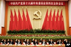 FILE - Senior members of the Standing Committee of the Political Bureau of the Chinese Communist Party are gathered at an assembly in Beijing, Sept. 19, 2004.