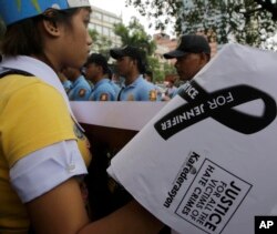 Demonstrators face off with police as they attempt to get closer to the U.S. Embassy in Manila, Philippines, to protest the killing of a Filipino transgender with the possible involvement of a U.S. serviceman, Oct. 14, 2014.