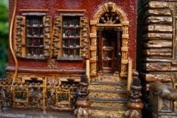 A miniature brownstone building is displayed during preparations for the annual Holiday Train Show in New York City, November 11, 2021.