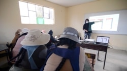 Parents attend a lesson on how to handle a smartphone for virtual home schooling for their children, during the coronavirus disease (COVID-19) outbreak, in El Alto, Bolivia July 12, 2021. Picture taken July 12, 2021. REUTERS/Claudia Morales