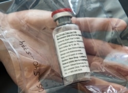 (FILES) In this file photo one vial of the drug Remdesivir is viewed during a press conference about the start of a study with the Ebola drug Remdesivir in particularly severely ill patients at the University Hospital Eppendorf (UKE) in Hamburg, northern
