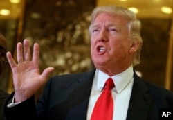President-elect Donald Trump speaks with reporters in the lobby of Trump Tower in New York. Trump has offered views on U.S. relations with Asia that could indicate radical shifts in long-standing policy toward the region.