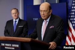 FILE - U.S. Commerce Secretary Wilbur Ross speaks next to White House press secretary Sean Spicer from the White House in Washington, April 25, 2017.