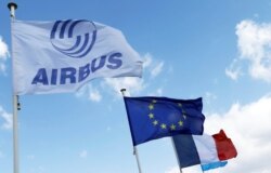 Flag with Airbus logo is pictured next to European and French flags at the Airbus A380 final assembly line at Airbus headquarters in Blagnac near Toulouse, France, March 21, 2018.