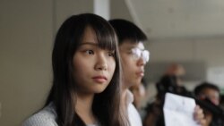 In this Friday, Aug. 30, 2019, photo, pro-democracy activists Joshua Wong, right, and Agnes Chow speak to media outside a district court in Hong Kong. (AP Photo/Kin Cheung)