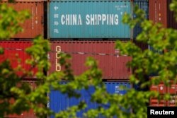 FILE - Shipping containers are stacked at the Paul W. Conley Container Terminal in Boston, Massachusetts, May 9, 2018.