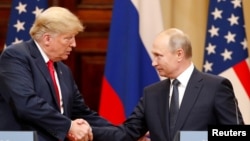 U.S. President Donald Trump and Russian President Vladimir Putin shake hands as they hold a joint news conference after their meeting in Helsinki, Finland July 16, 2018. REUTERS/Grigory Dukor