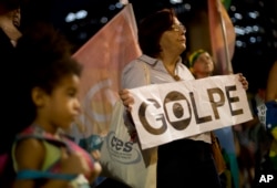A pro-government demonstrator holds a sign that reads in Portuguese "Coup" during a protest against the impeachment of Brazil's President Dilma Rousseff in Rio de Janeiro, Brazil, May 11, 2016.