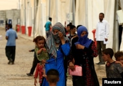 Displaced people, who fled from homes are seen at Hamam al-Alil camp south of Mosul, Iraq July 13, 2017.