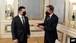 Ukrainian President Volodymyr Zelensky, left, shares a word with United States Secretary of State Antony Blinken on the occasion of their meeting at the Bankova, in Kyiv, Ukraine, Jan. 19, 2022, in Kyiv, Ukraine.