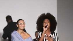 Designer Stella Jean joins the band Soul Voices at the end of her fashion show in Milan, Italy, Sunday, September 24, 2017. (AP Photo/Luca Bruno)