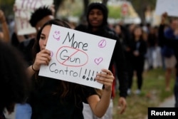 Students from South Plantation High School carrying placards and shouting slogans walk on the street during a protest in support of the gun control, following a mass shooting at Marjory Stoneman Douglas High School