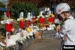 Marybeth Kelly looks at memorials along a bike path to remember the victims of the New York Oct. 31 attack, in New York, Nov. 3, 2017.