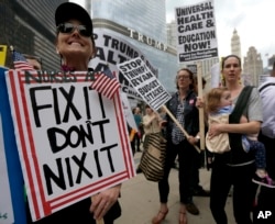 Protesters in Chicago gather across the Chicago River from Trump Tower to rally against the effort to overhaul the Affordable Care Act, March 24, 2017.