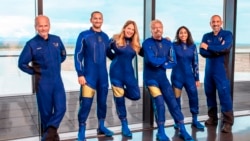 This image provided by Virgin Galactic shows, from left: Chief Pilot Dave Mackay, Lead Operations Engineer Colin Bennett, Chief Astronaut Instructor Beth Moses, Founder of Virgin Galactic Richard Branson, Vice President of Government Affairs and Research Operations Sirisha Bandla and pilot Michael Masucci. (Virgin Galactic via AP)