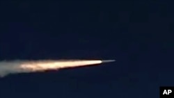FILE - In this photo made from the footage taken from Russian Defense Ministry official web site on March 11, 2018, a Russia's Kinzhal hypersonic missile flies during a test in southern Russia. 
