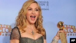 Madonna poses backstage with the award for Best Original Song in a Motion Picture for the song "Masterpiece" from the film "W.E." during the 69th Annual Golden Globe Awards on January 15, 2012, in Los Angeles. (AP)