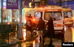 People run from a nightclub where a gun attack took place during a New Year party in Istanbul, Jan. 1, 2017.