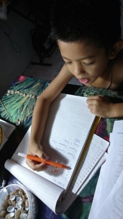 Ryuben (6) belajar matematika di rumahnya di Kutai Kartanegara, tanpa harus memakai baju. (Foto: PHI via Ellen)