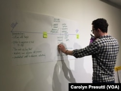 Participant Tyler Phillips decides where to place an act of discrimination on the spectrum graph at a sexual harassment seminar at The Potter's House in Washington, D.C.