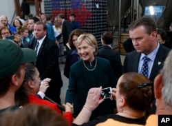 Democratic presidential candidate Hillary Clinton shakes hands with the audience during a campaign stop at Jackie O's Production Brewery and Tap Room in Athens, Ohio, May 3, 2016.