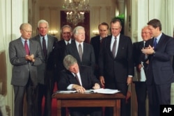 U.S. President Bill Clinton signs side deal of the three-nation North American Free Trade Agreement (NAFTA) at the White House, Washington, D.C., Tuesday, Sept. 14, 1993.