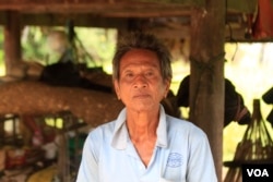 Mey Chham, 69, a resident of Sovong village in Taches commune, was uncomfortable telling his village chief he did not want to join the CPP when she came to his house and asked for photographs of each of his family members to register them in a CPP family book. (Sun Narin/VOA Khmer)