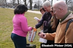 The vigil ends with each person taking a handful of dirt to spread on the Capitol grounds — an effort to sow the seeds of change, said Patrick Carolan of the Franciscan Action Network. (Credit: Elizabeth Pfotzer)