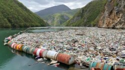 In this photo taken on Tuesday, April 23, 2019, plastic bottles and other garbage float in the river Drina near Visegrad, eastern Bosnia-Herzegovina. (AP Photo/Eldar Emric)
