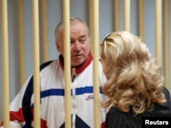 FILE - Sergei Skripal, a former Russian military intelligence officer, looks on inside the defendants' cage at a hearing Aug. 9, 2006.