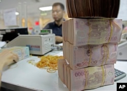 FILE - Vietnamese Dong is seen in Asia Commercial Bank in Hanoi, Vietnam.