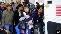 Immigrants from El Salvador and Guatemala, who entered the country illegally, board a bus after they were released from a family detention center in San Antonio, Texas in 2015.