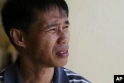 Nasir Abdul watches air strike operations from the window of a temporary evacuation center at the provincial government capitol in Marawi city, southern Philippines, June 9, 2017.