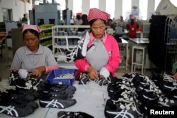 រូបឯកសារ៖ កម្មករ​កំពុង​ដោត​ខ្សែ​ស្បែក​ជើង​ក្នុង​រោងចក្រ​ស្បែក​ជើង​មួយ​របស់​ក្រុមហ៊ុន​តៃវ៉ាន់​ ក្នុង​ខេត្ត​កំពង់ស្ពឺ ថ្ងៃ​ទី៤ ខែកក្កដា ឆ្នាំ​២០១៨។