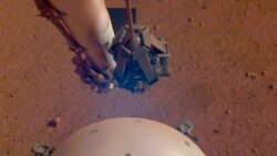 This photo made available by NASA on Tuesday, April 23, 2019 shows the Mars InSight lander's domed wind and thermal shield which covers a seismometer. (NASA/JPL-Caltech via AP)