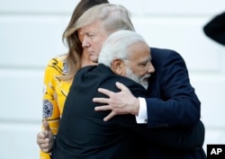 FILE - Indian Prime Minister Narendra Modi hugs President Donald Trump as Modi departs the White House, June 26, 2017.
