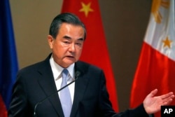 FILE - Chinese Foreign Minister Wang Yi gestures during a joint news conference with Philippine Foreign Affairs Secretary Alan Peter Cayetano in suburban Taguig city, east of Manila, Philippines, July 25, 2017.