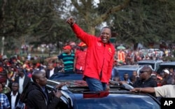 Kenya's President Uhuru Kenyatta gestures to supporters as he leaves an election rally at Uhuru Park in downtown Nairobi, Kenya, Sept. 9, 2017.
