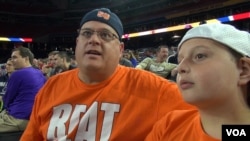 Twelve-year-old Tyler Hathaway and his father, Eric, came all the way from Rochester, New York, to support the Syracuse team at the Final Four in Houston, Texas. It's a "huge opportunity," Eric says. (G. Flakus/VOA)