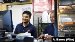 Employees tend to customers at Aladdin Sweets & Cafe in Banglatown, Hamtramck, Michigan.