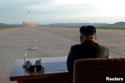 North Korean leader Kim Jong Un watches the launch of a Hwasong-12 missile in this undated photo released by North Korea's Korean Central News Agency, Sept. 16, 2017.