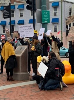 Somnuk Pulling (L), a Thai royalist stands guard at the monument facing a group of Pro-Thai Democracy protesters at the King Bhumibol Adulyadej Square in Cambridge, MA. Nov 22, 2020.
